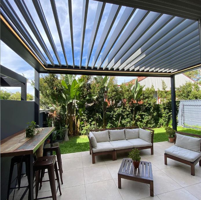 Louvered pergola over a garden lounge